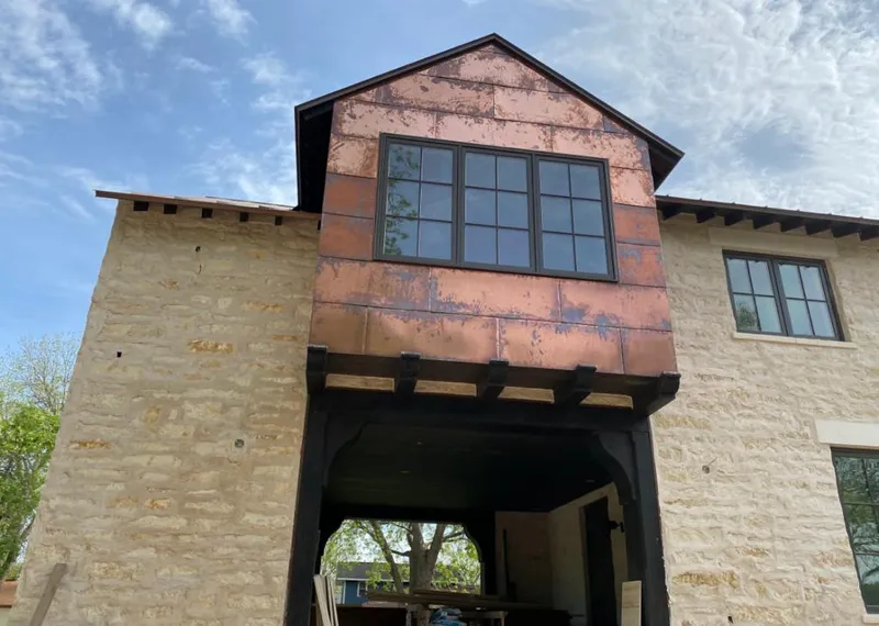 Copper metal panel facade on a stone building for Roof Repair in Ponca City