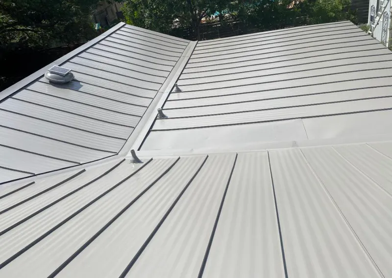 Solar attic fan installed on a metal roof for Roof Ventilation in Ponca City